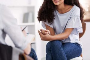 a woman sits in cocaine addiction treatment
