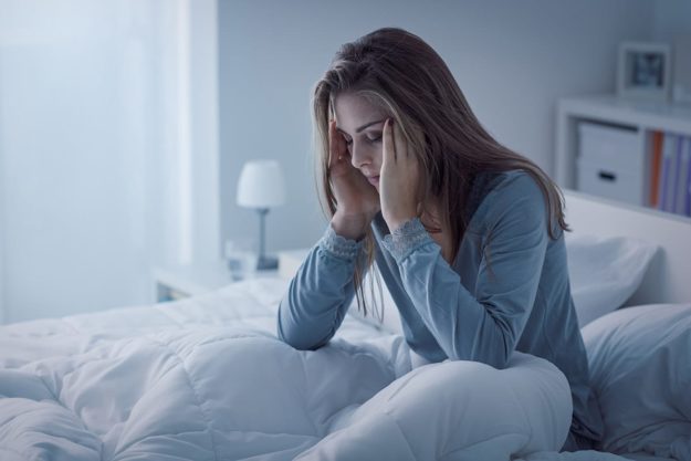 A woman struggling to sleep during Opiate Withdrawal management