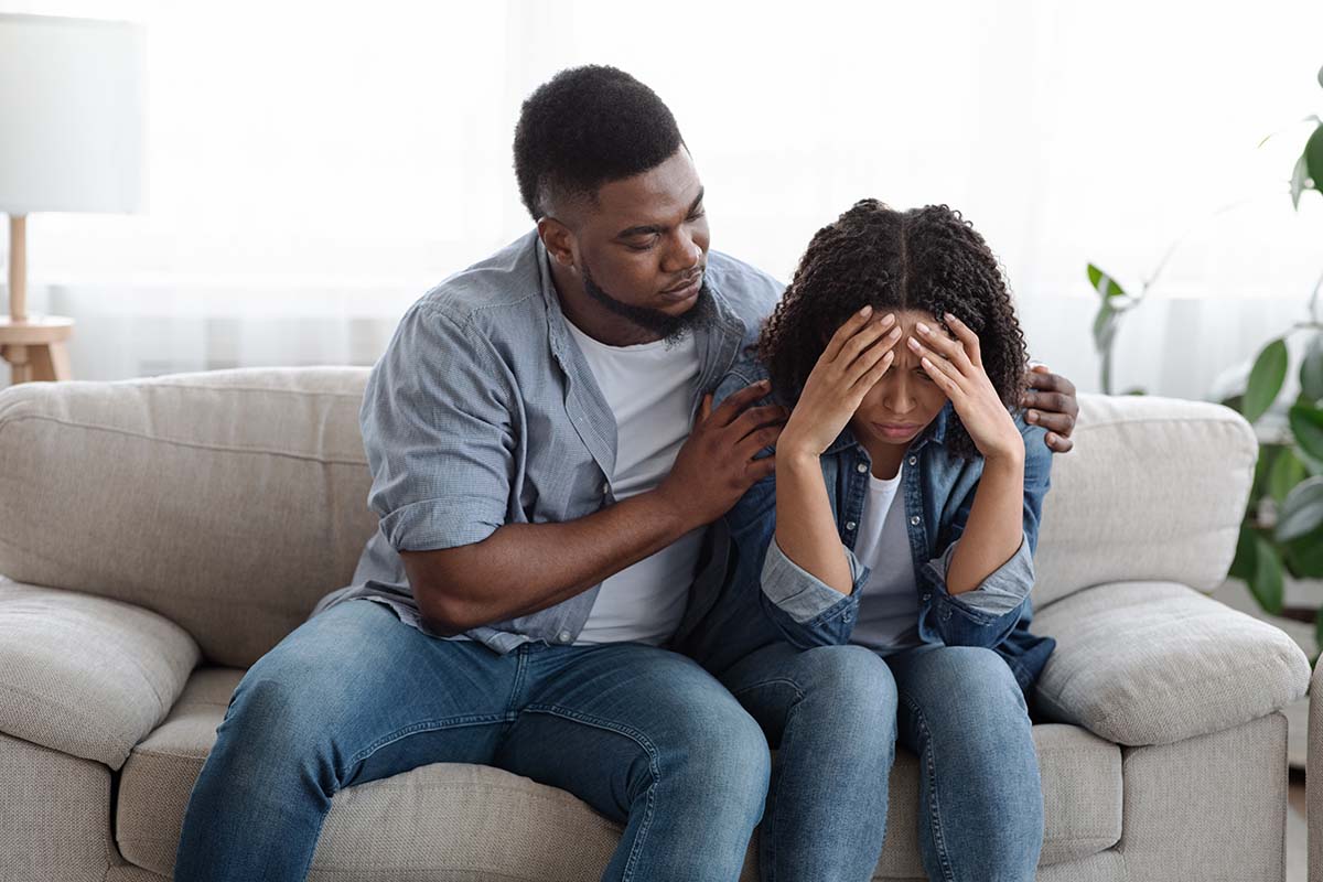 a man consoling his wife about spouse drug addiction
