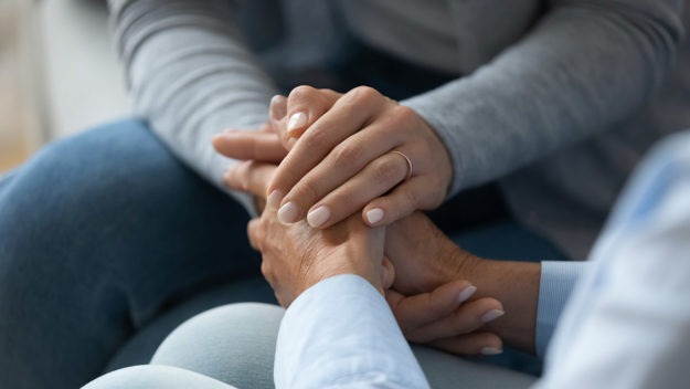 two people holding hands as a support system