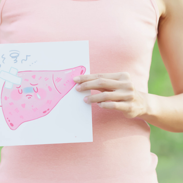 photo of a woman with a pink shirt holding a photo of a liver with a band aid indicating it needs to heal